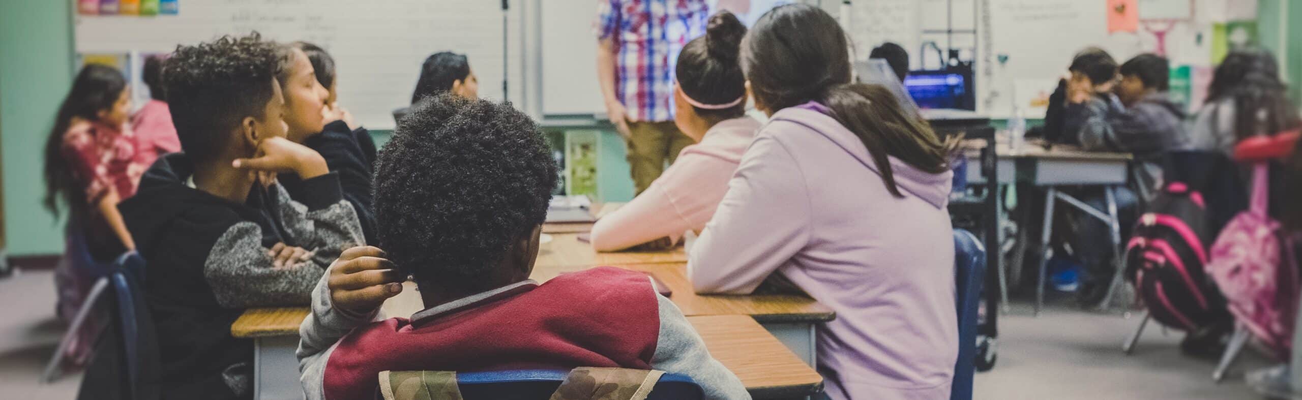 Classroom setting with students and teacher, related to child psychotherapy and mental health support.